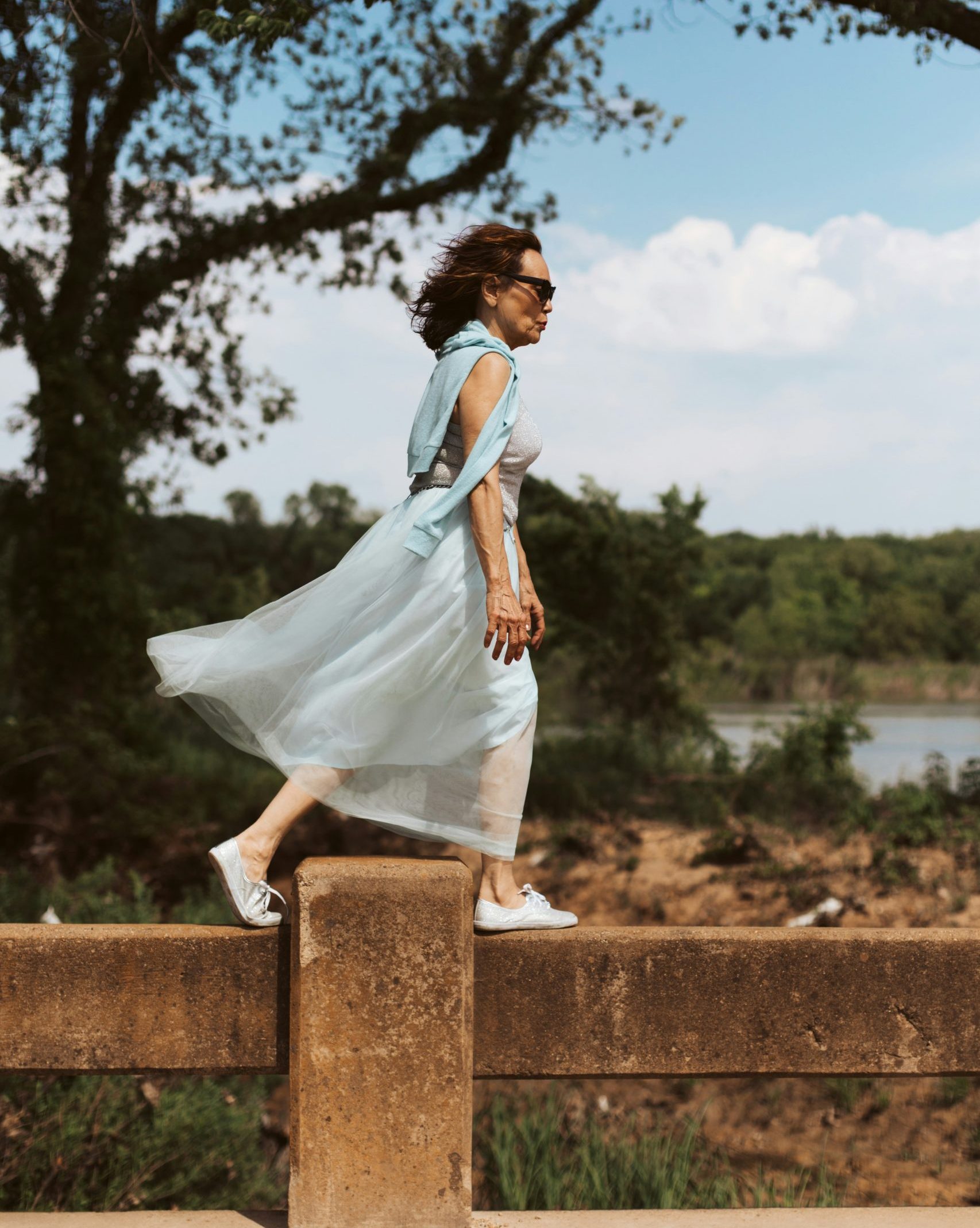 Woman with excellent balance walking on fence Woman with excellent balance walking on fence